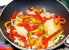 saute chopped onion and capsicum in a pan 22985